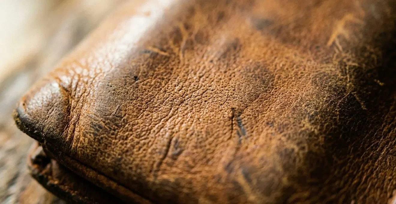 Gros plan sur la texture d'un cuir naturel montrant des variations de grain et une légère patine